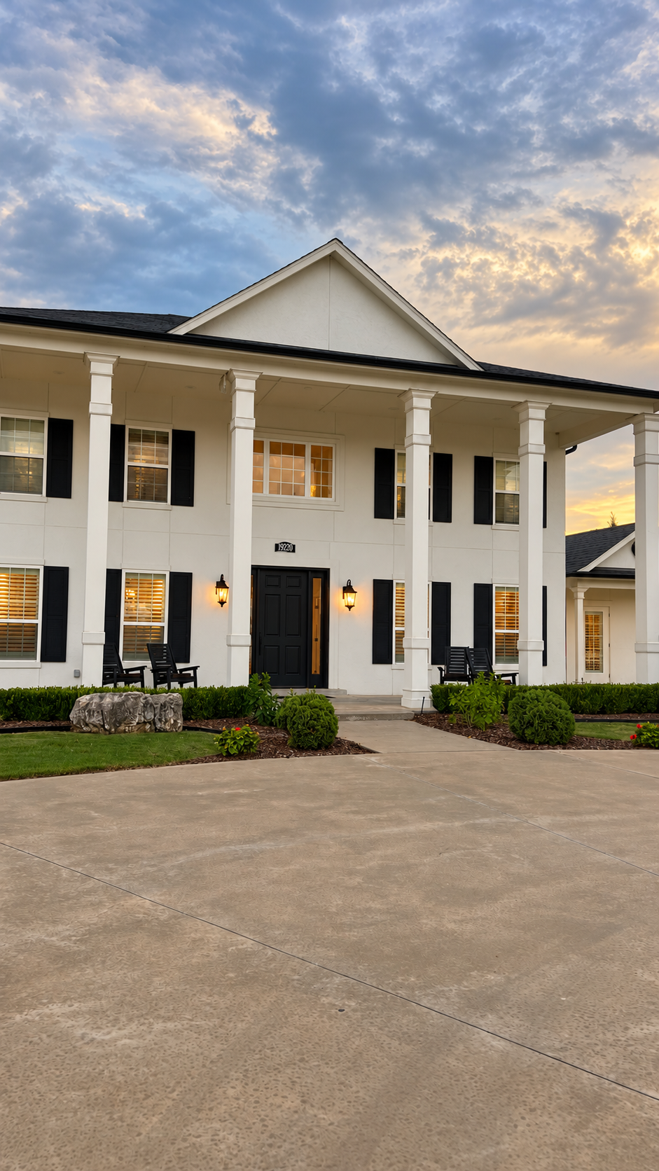 White-columned home photographed in the evening
